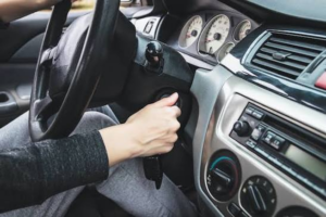 Hand turning a car key in the ignition